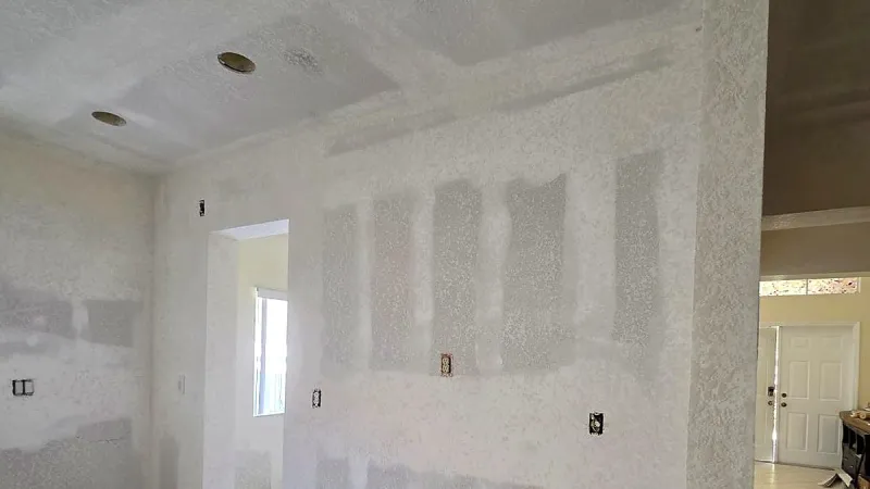 Walls patched and skim coated with joint compound, ready for sanding, Miami